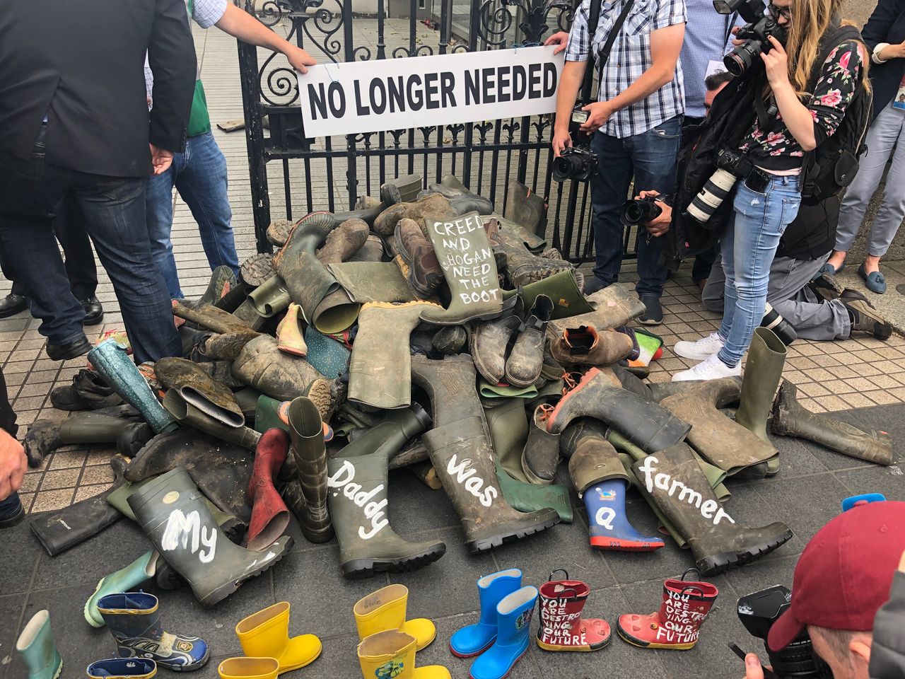 Fuming farmers pile 'redundant wellies' at gates of Leinster House