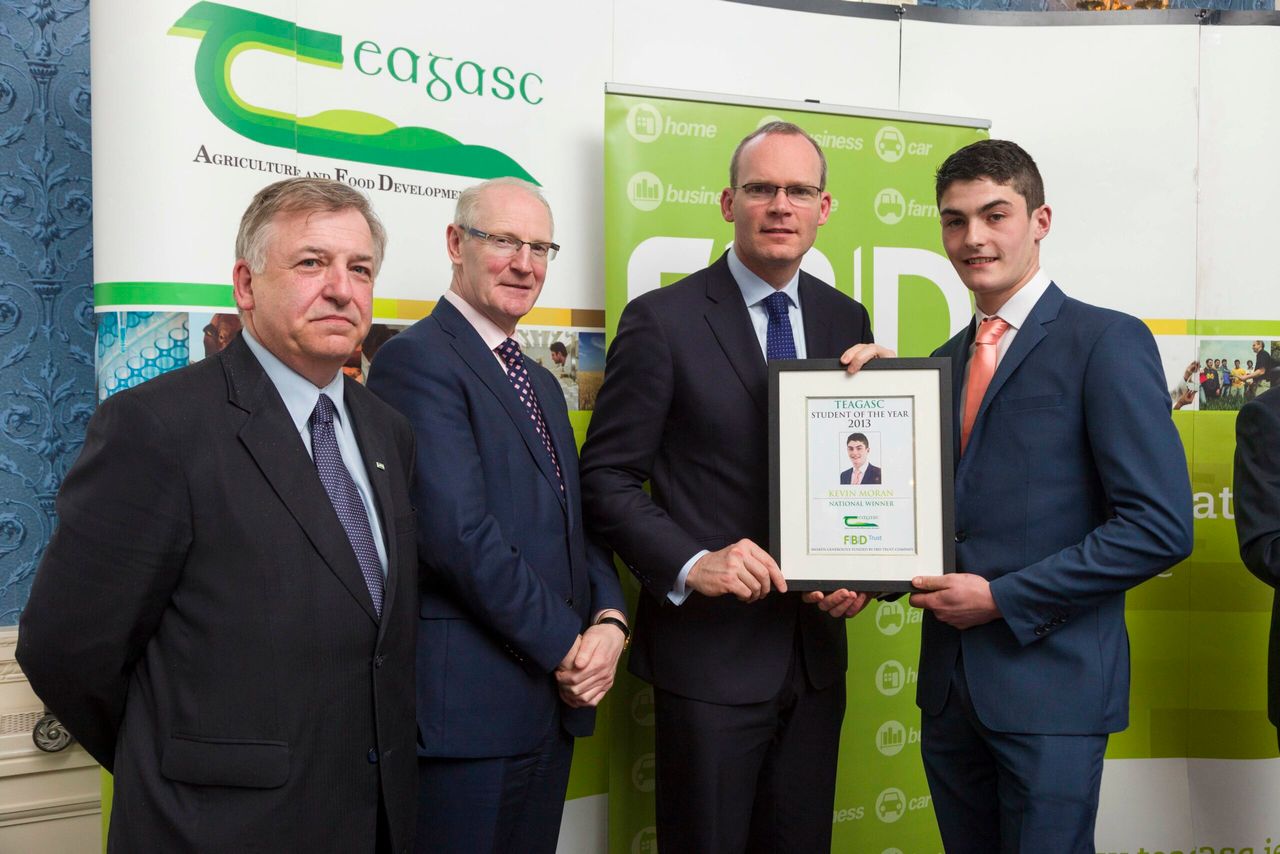 Prof. Gerry Boyle, Director Teagasc with Michael Garvey, Director Of Marketing And Sales FBD, and Minister for Agriculture, Food & the Marine Simon Coveney,  present Kevin Moran, Shessagh, Taugheen, Claremorris, Co. Mayo, with the Teagasc/FBD Student of the Year award. 
