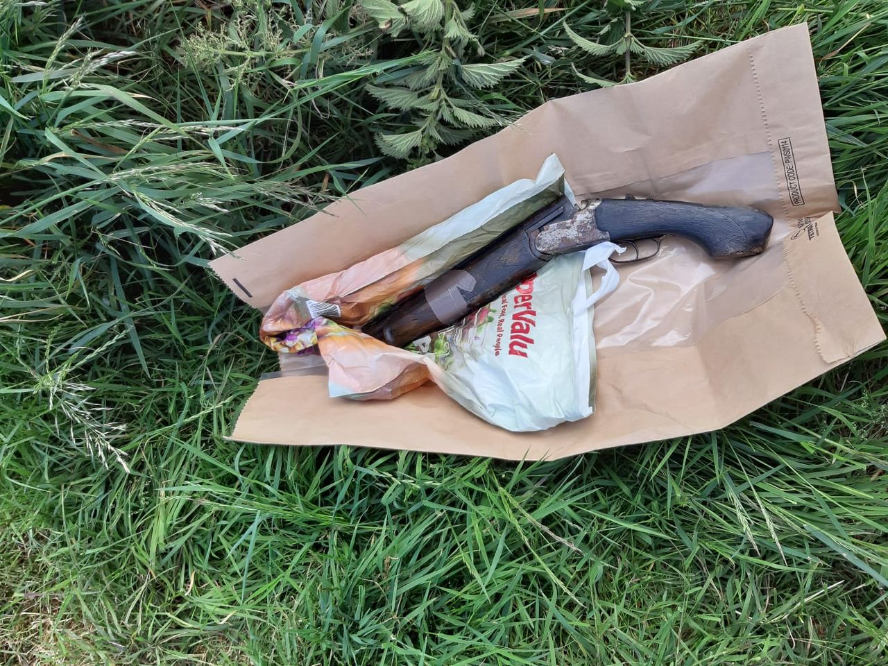 Sawn-off shotgun 'concealed behind water trough' in field