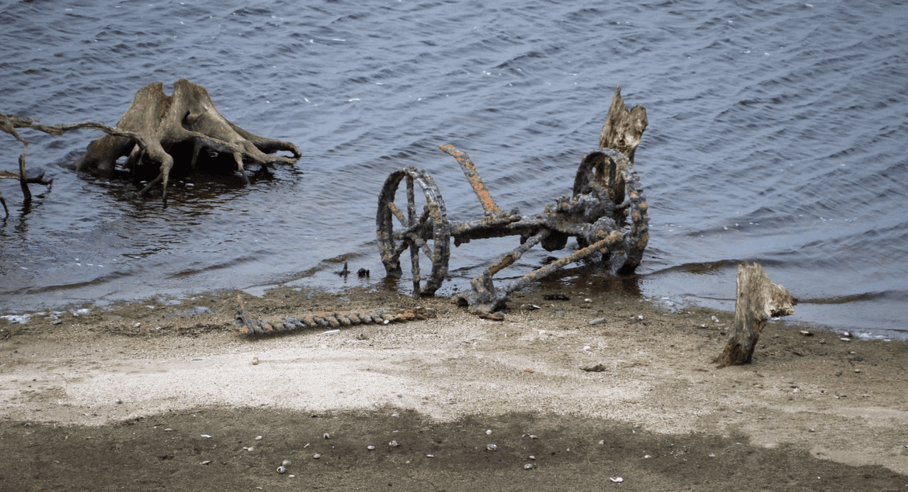 Ruins of homestead and farm machinery in lake uncovered