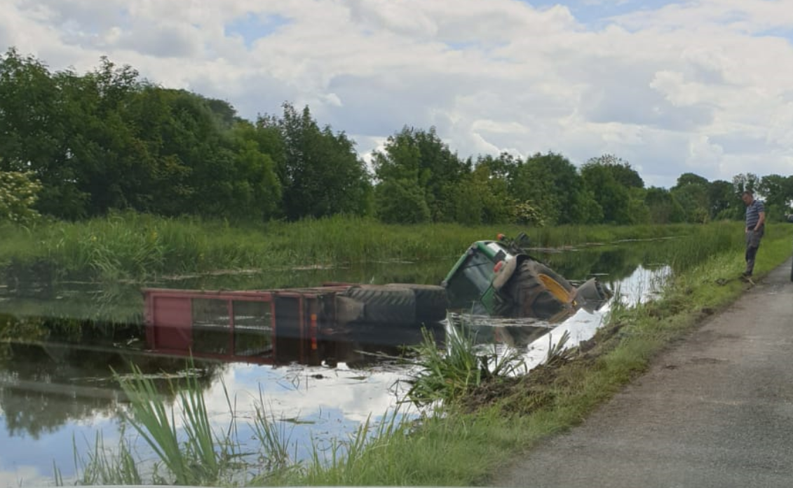 Tractor and silage trailer slides into Royal Canal