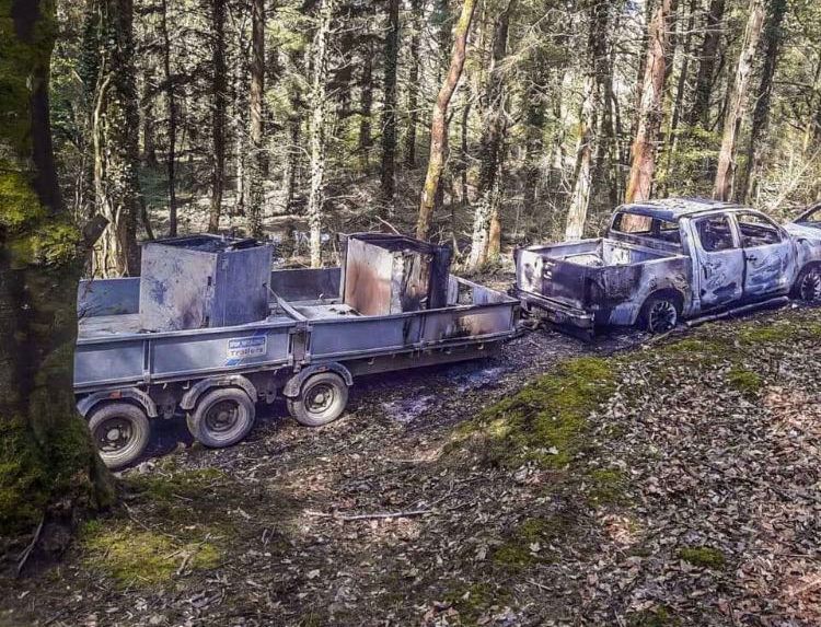 Bank robbery getaway vehicle discovered burned out in wood