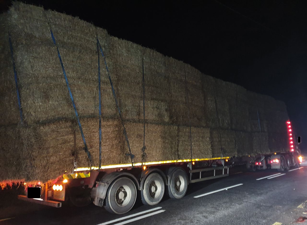 Court summons after extended flatbed lorry with straw stopped
