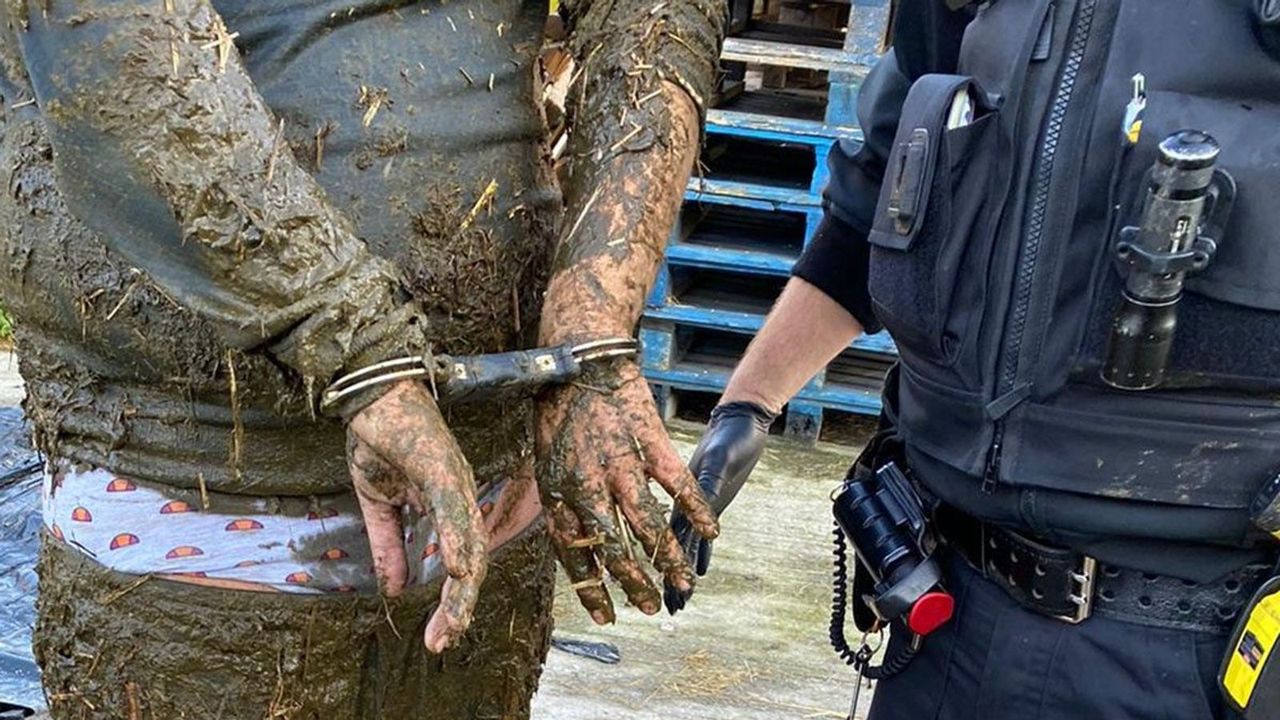 Man arrested after falling 'neck-deep' into slurry pit after police chase