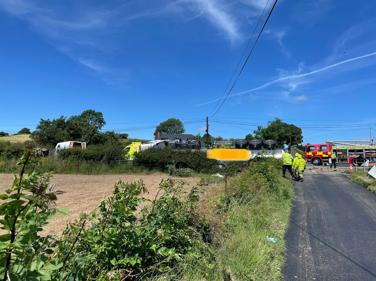 Gardaí and fire brigade attend scene of overturned milk lorry