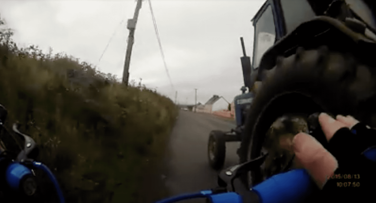 Dramatic footage of a tractor almost knocking a cyclist off their bike!