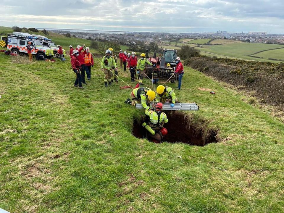 Farmer rescued after falling down 60ft sinkhole in field