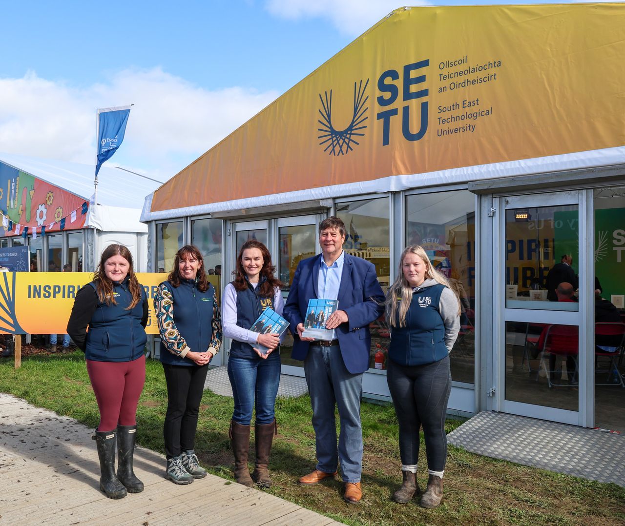 Pictured at SETU’s Ploughing stand: Dr. Mary-Kate Burke, head of the Department of Veterinary Medicine at SETU (centre); Dr. Anne Marie Butler, head of education in Teagasc; Paul Nolan, Dawn Meats Group Development Manager; with fourth-year agri-science students from SETU.