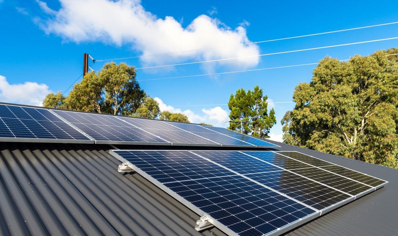 Who is eligible to sell surplus electricity back to the grid?
